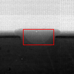 An x-ray image of a metallic sample with a red box
                         overlaid on the region melted by a laser